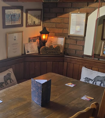 Cosy corner inside The Cross Inn with warm lamp light